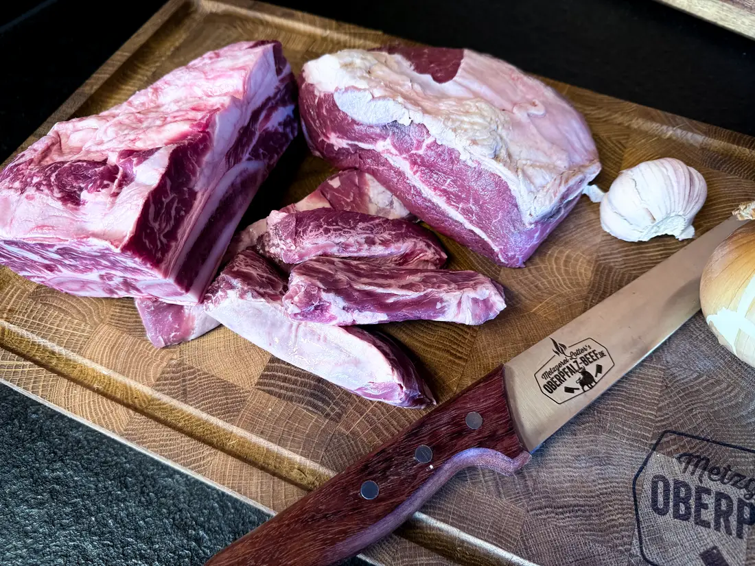 Rindernacken und Short Ribs mit Knoblauch und Zwiebel auf dem Schneidebrett