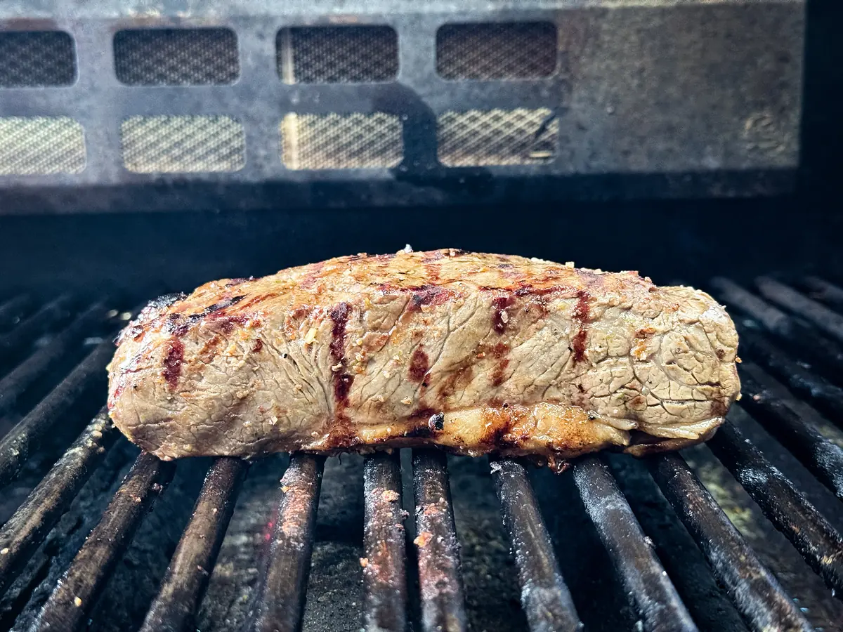 Mariniertes Steak mit Grillstreifen auf dem Rost