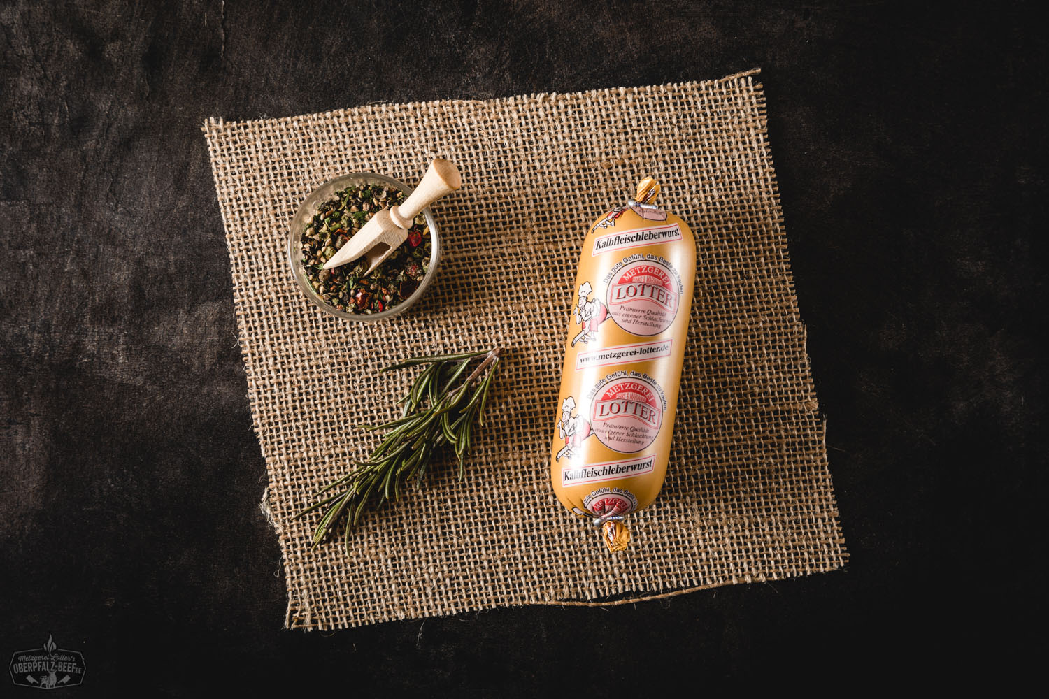 Kalbfleisch-Leberwurst Mini im Glas – Feine Delikatesse aus der Oberpfalz Kalbsleberwurst in Mini-Gläsern auf Holzunterlage, Vordergrund zeigt geöffnetes Glas mit cremiger Leberwurst, dekoriert mit frischem Brot, Zwiebeln und Petersilie – hochwertige Kalbfleisch-Leberwurst aus der Oberpfalz, traditionell hergestellt.