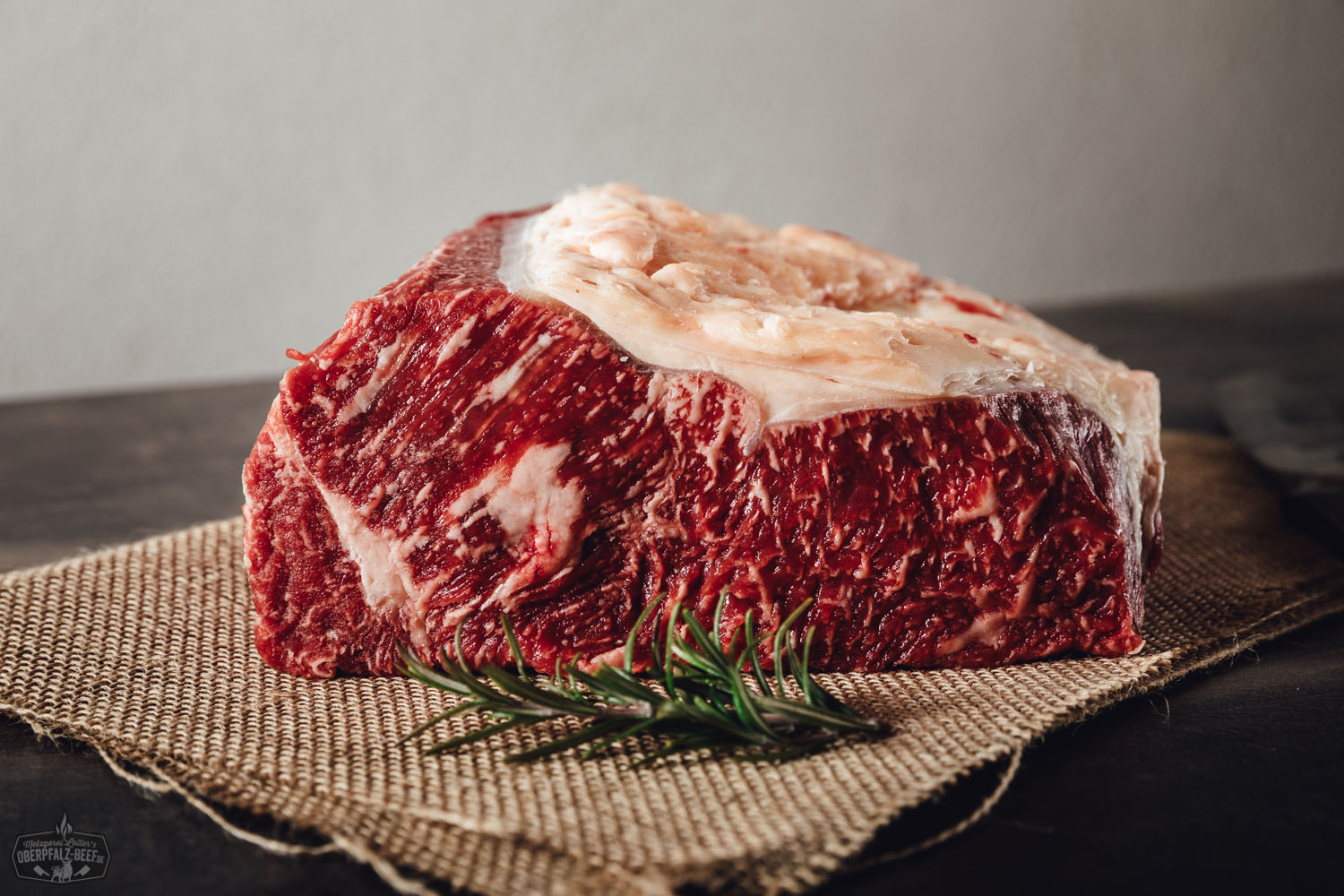 Roastbeef am Stück – Wet Aged vom Oberpfalz-Rind Roastbeef am Stück vom Oberpfalz-Rind, roh und wet-aged gereift, mit feiner Marmorierung, auf einem Holzbrett angerichtet – hochwertige Fleischspezialität für Rindfleisch-Liebhaber.