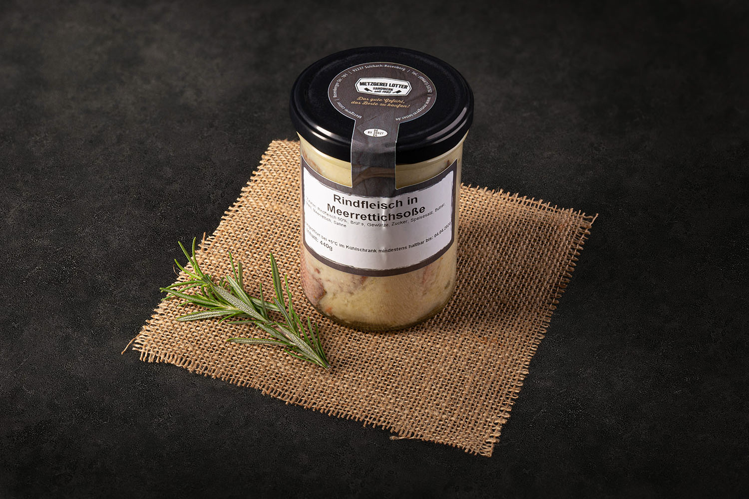 Rindfleisch in cremiger Meerrettichsoße im Einmachglas – fein geschnittenes Fleisch in weißer Soße, serviert in einem Weckglas mit Deckel, auf einem Holzbrett mit rustikalem Hintergrund – traditionelle bayerische Spezialität.